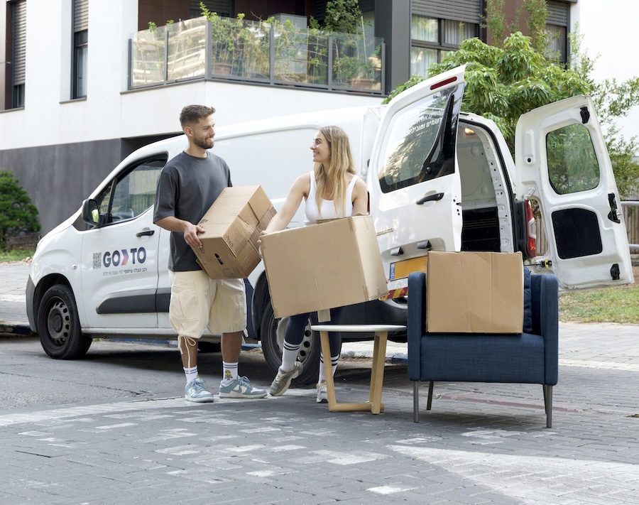 A couple using GoTo car sharing's van service to move furniture and boxes with ease. GoTo car sharing offers flexible and affordable access to vans, making it simple for users to handle larger transport needs without owning a vehicle.