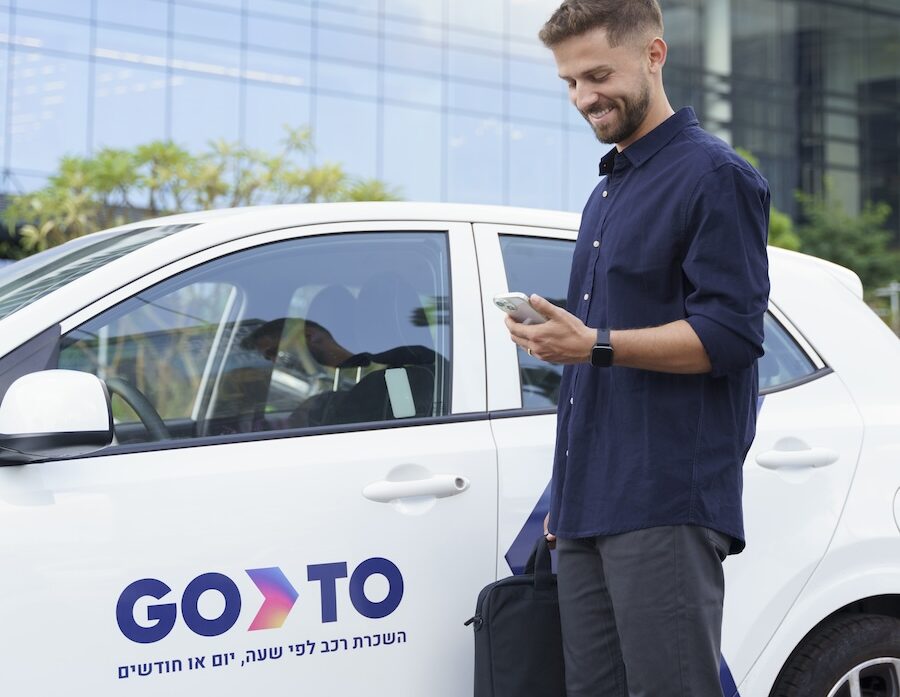 A professional using GoTo's car sharing service, unlocking a vehicle with ease through the mobile app. GoTo offers a flexible and convenient way to rent cars by the hour or day, making transportation for work or personal errands hassle-free.