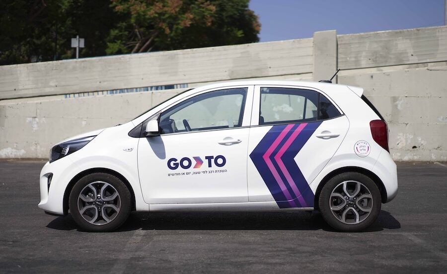 A GoTo branded compact car parked, showcasing the rent a car by the hour service for flexible city travel.